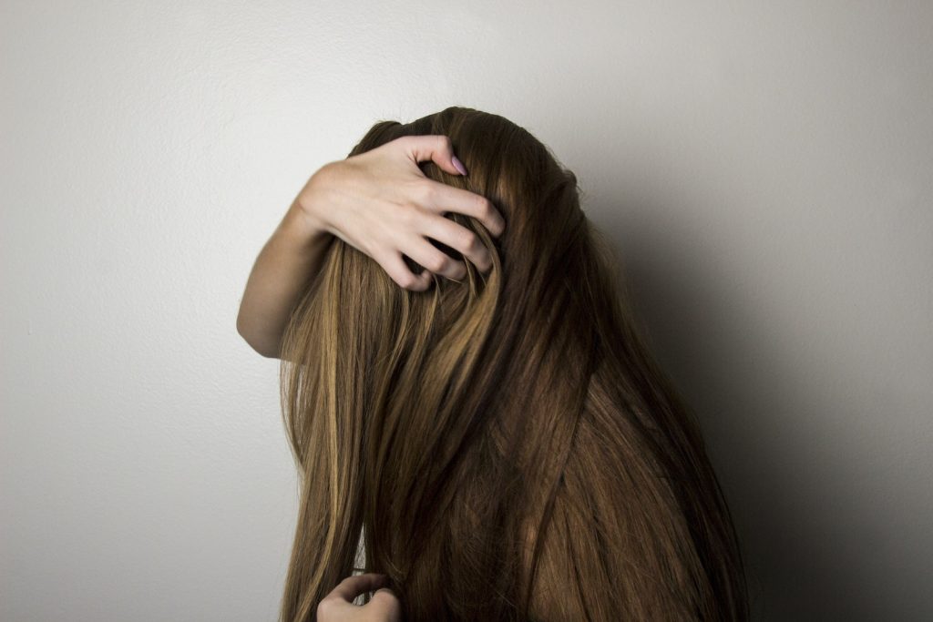 Photo of Woman Covering Face with Her Hair.